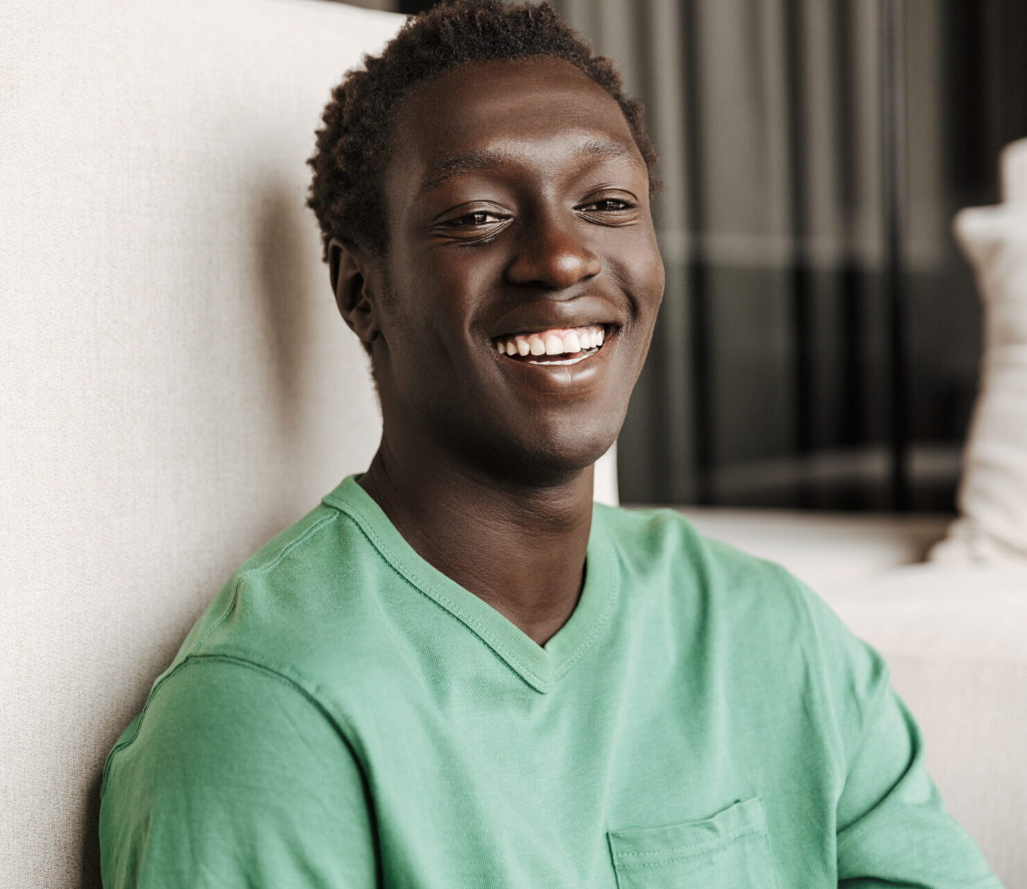 smiling-man-in-green-shirt-leaning-on-wall-2026-09-22-00-27-56-utc (1)